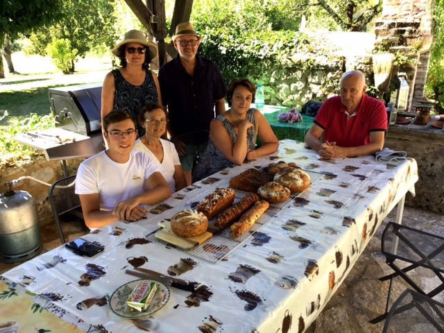 people around the table with breads